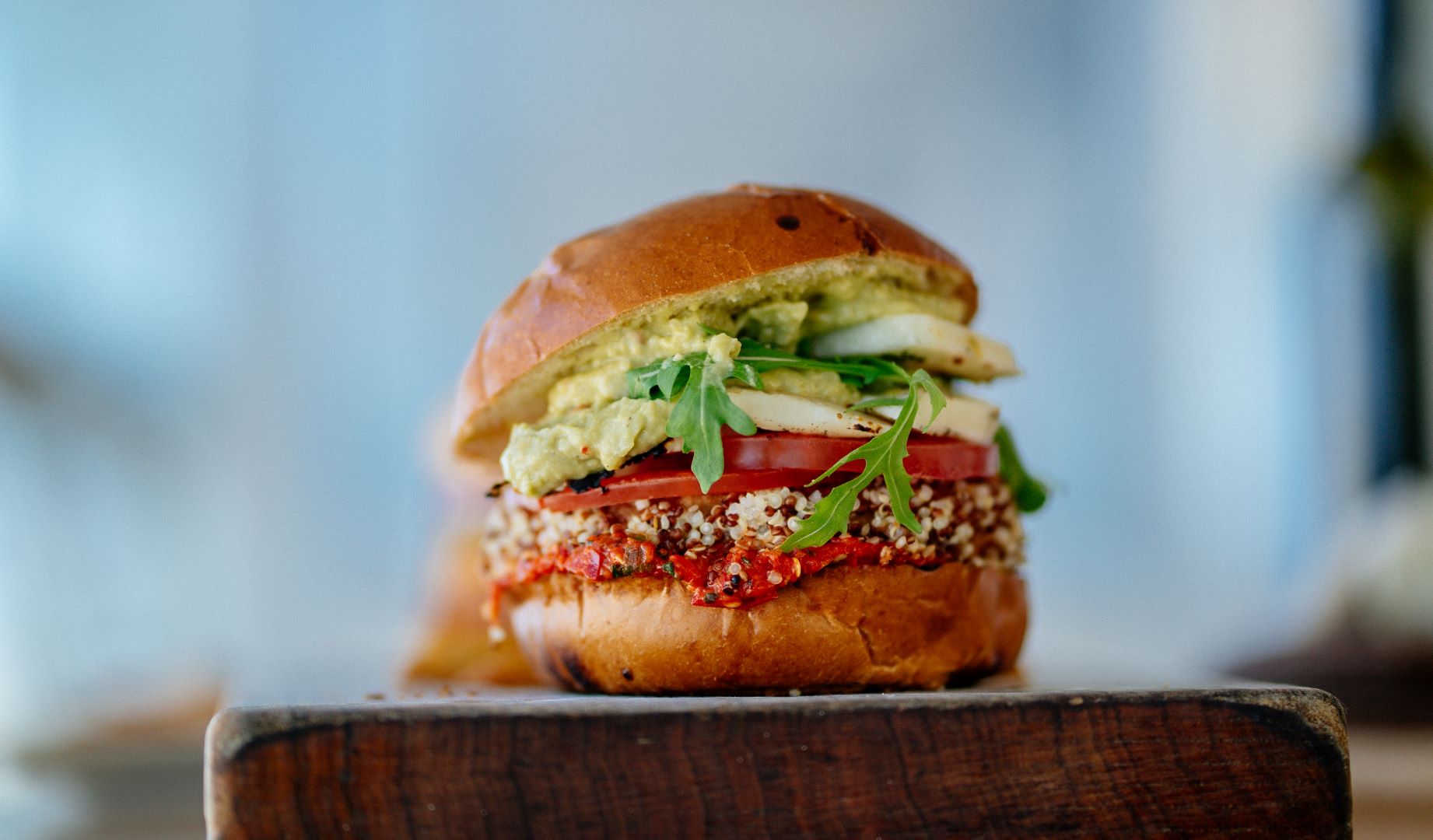 a vegetarian burger with a quinoa patty and lots of vegetable fixins.